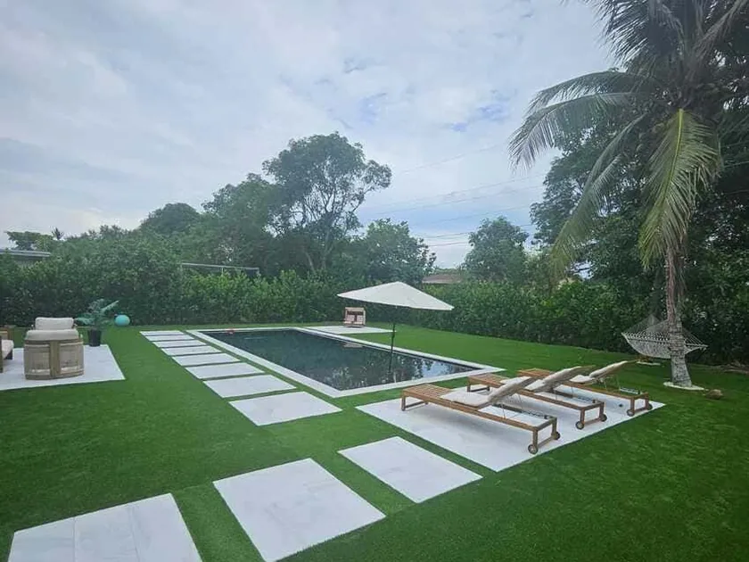 Backyard with pool, artificial turf and oversized porcelain stepping pads